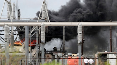 Plant workers watch a transformer fire as the Texas City Fire Department responds at the Ashland chemical plant on Tuesday, Sept. 17, 2019. There have been no reported injuries and there are no threats to the community.