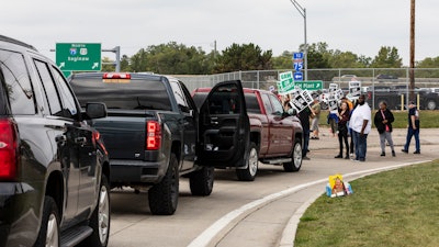 Protesting union members prevent cars from driving into the General Motors Flint Assembly Plant on Bristol Road as United Automobile Workers remain on strike against GM.