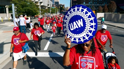 United Auto Workers members walk in the Labor Day parade in Detroit, Monday, Sept. 2, 2019.