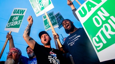 General Motors employees Bobby Caughel, left, and Flint resident James Crump, shout out as they protest with other GM employees, United Auto Workers members and labor supporters outside of the Flint Assembly Plant on Monday, Sept. 16, 2019 in Flint, Mich. Thousands of members of the United Auto Workers walked off General Motors factory floors or set up picket lines early Monday as contract talks with the company deteriorated into a strike.