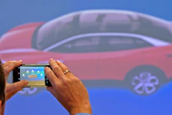 In this Tuesday, May 14, 2019 file photo, a journalist takes photographs during a presentation of the new electric 'ID.3' car at a press tour of the plant of the German manufacturer Volkswagen AG (VW) in Zwickau, Germany. Volkswagen is rolling out what it bills as the breakthrough electric car for the masses, the leading edge of a wave of new battery-powered vehicles about to hit the European auto market. The ID.3 is going on display ahead of the Frankfurt Motor Show on Monday Sept. 9, 2019.