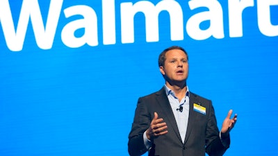 In this June 2, 2017 file photo, Walmart CEO Doug McMillon speaks during the Walmart shareholders meeting at Bud Walton Arena in Fayetteville, Ark. The Business Roundtable, a group that represents the most powerful companies in America, is naming McMillon as its new chairman. McMillon succeeds JPMorgan Chase Chairman and CEO Jamie Dimon in the role. Dimon will continue to serve as a board member after completing his tenure as the group's chairman at year's end.