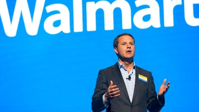 In this June 2, 2017 file photo, Walmart CEO Doug McMillon speaks during the Walmart shareholders meeting at Bud Walton Arena in Fayetteville, Ark. The Business Roundtable, a group that represents the most powerful companies in America, is naming McMillon as its new chairman. McMillon succeeds JPMorgan Chase Chairman and CEO Jamie Dimon in the role. Dimon will continue to serve as a board member after completing his tenure as the group's chairman at year's end.
