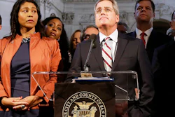 In this Dec. 12, 2017 file photo, city attorney Dennis Herrera, center, speaks at a news conference next to acting mayor London Breed, left, at City Hall in San Francisco. San Francisco officials are offering to buy Pacific Gas & Electric's power lines and other infrastructure in the city for $2.5 billion. Mayor London Breed and City Attorney Dennis Herrera presented the offer in a letter sent to the utility Friday, Sept. 6, 2019.