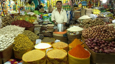 A merchant displays powdered and whole spices, including turmeric in the Karwan Bazar of Dhaka, Bangladesh.