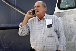 In this Oct. 14, 2014, file photo, Carlos Rafael talks on the phone at Homer's Wharf near his herring boat F/V Voyager in New Bedford, Mass. Rafael was sentenced to prison in 2017 after pleading guilty to evading fishing quotas and smuggling profits overseas. A father-and-son team from Massachusetts and other buyers are acquiring scallop fishing boats owned by the disgraced fishing magnate nicknamed the Codfather. The sale of Rafael’s 11 scallop boats and their related permits signals the beginning of his forced divestment from U.S. fisheries. The federal government is making the imprisoned Rafael sell his fishing assets as part of a civil settlement.