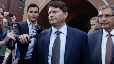 Devin Sloane, middle, leaves federal court after his sentencing in a nationwide college admissions bribery scandal, Tuesday, Sept. 24, 2019, in Boston.