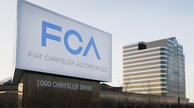 In this May 6, 2014, file photo, a vehicle moves past a sign outside Fiat Chrysler Automobiles world headquarters in Auburn Hills, MI.