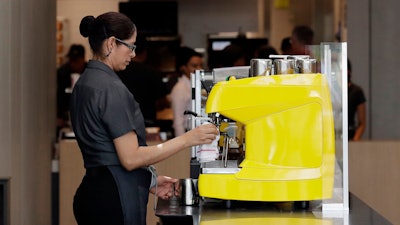 In this Aug. 8, 2018, photo an employee works at a McDonald's restaurant in Chicago. The Trump administration has issued a rule that will make overtime pay available to 1.3 million additional workers, though the proposal replaces a more generous one advanced by former President Barack Obama. The Labor Department said Tuesday, Sept. 24, 20119, that it is raising the salary level that companies will have to pay to exempt workers from overtime to $35,308 a year, up from $23,660.