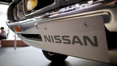 In this May 11, 2017 file photo, a Nissan car is displayed at its showroom in Tokyo. Nissan is recalling 1.3 million vehicles in the U.S., Canada and other countries to fix a problem with backup camera displays. The recall covers most of the Nissan and Infiniti model lineups from the 2018 and 2019 model years.