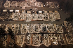 This Nov. 15, 2018, aerial file photo shows the remains of residences leveled by the Camp wildfire in Paradise, Calif. Pacific Gas & Electric and a group of insurers say they have reached an $11 billion settlement to cover most of the claims from the 2017 and 2018 wildfires in California. The utility said in a statement Friday, Sept. 13, that the tentative agreement covers 85% of the insurance claims, including a fire that decimated the town of Paradise.
