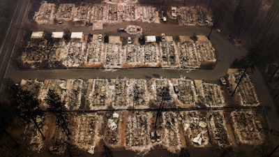 This Nov. 15, 2018, aerial file photo shows the remains of residences leveled by the Camp wildfire in Paradise, Calif. Pacific Gas & Electric and a group of insurers say they have reached an $11 billion settlement to cover most of the claims from the 2017 and 2018 wildfires in California. The utility said in a statement Friday, Sept. 13, that the tentative agreement covers 85% of the insurance claims, including a fire that decimated the town of Paradise.