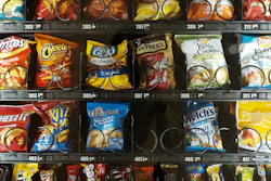 This Saturday, Sept. 7, 2019 photo shows items in a vending machine in New York. Americans are addicted to snacks, and food experts are paying closer attention to what that might mean for health and obesity.