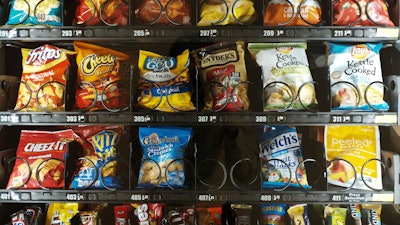 This Saturday, Sept. 7, 2019 photo shows items in a vending machine in New York. Americans are addicted to snacks, and food experts are paying closer attention to what that might mean for health and obesity.