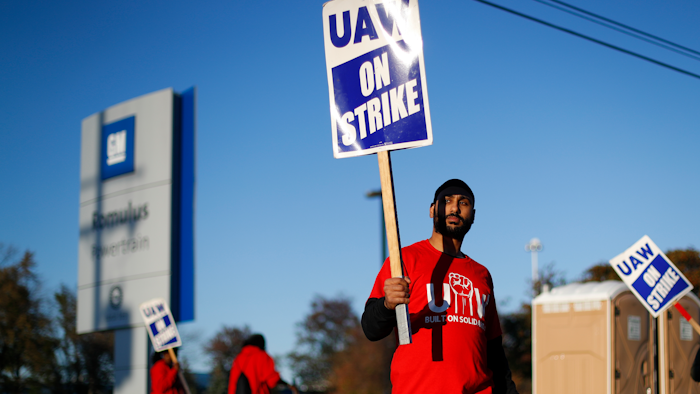 A member of the United Auto Workers walks the picket line at the General Motors Romulus Powertrain plant in Romulus, MI on Oct. 9.