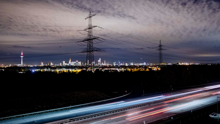 Cars pass by near the skyline with the buildings of the banking district in Frankfurt, Germany, on Tuesday, Oct. 22.