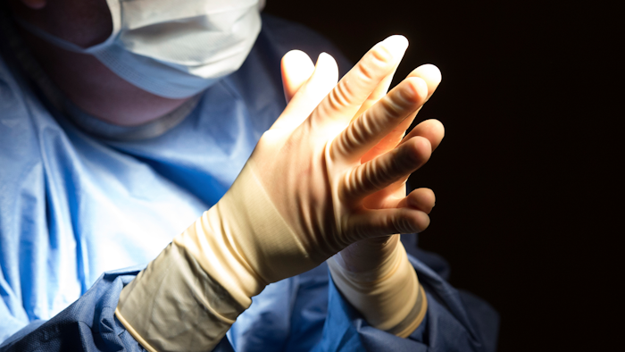 In this June 28, 2016 file photo, a doctor prepares for a surgical procedure at a hospital in Washington.