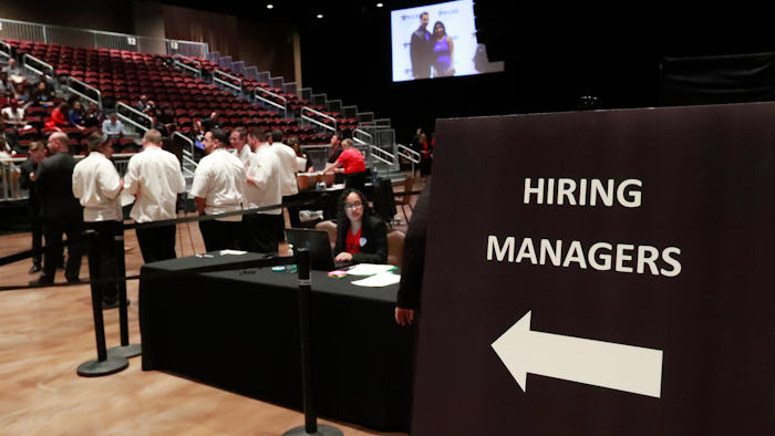 In this Tuesday, June 4, 2019 file photo, managers wait for job applicants at the Seminole Hard Rock Hotel & Casino Hollywood during a job fair in Hollywood, FL.