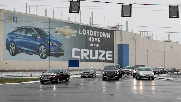 In this Nov. 27, 2018 file photo, a banner depicting the Chevrolet Cruze model vehicle is displayed at the General Motors' Lordstown plant in Lordstown, Ohio. An economic renaissance in the industrial Midwest promised by President Donald Trump has suffered in recent weeks in ways that could be problematic for Trump's 2020 re-election.