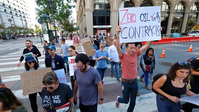 In this Friday, Sept. 20, 2019 file photo, Google employees make their way up Market Street to join others in a climate strike rally at City Hall, in San Francisco. Microsoft and other tech giants have been competing to strike lucrative partnerships with ExxonMobil, Chevron, Shell, BP and other energy firms. The deals have been met with internal opposition from environmentally-minded tech workers.