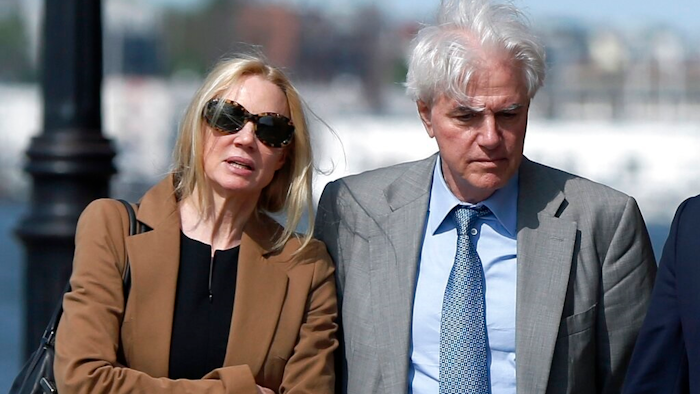 In this May 22, 2019 file photo, Marcia, left, and Gregory Abbott leave federal court after they pleaded guilty to charges in a nationwide college admissions bribery scandal. They are scheduled to be sentenced on Tuesday, Oct. 8.