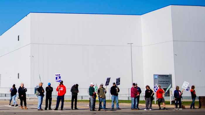 General Motors' Flint Assembly Plant employees line the street with picket signs during the nationwide UAW strike against General Motors on Monday, Oct. 7, 2019, in Flint, Mich.