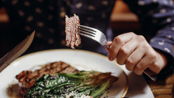 Man Eating Steak
