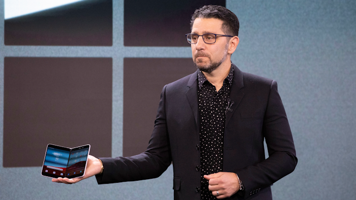 Microsoft's Chief Product Officer Panos Panay holds a Surface Duo.