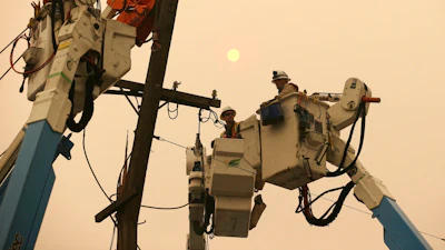 In this Nov. 9, 2018, file photo, Pacific Gas & Electric crews work to restore power lines in Paradise, Calif. Two years to the day after some of the deadliest wildfires tore through Northern California wine country, two of the state's largest utilities were poised Tuesday, Oct. 8, 2019, to shut off power to more than 700,000 customers in 37 counties, in what would be the largest preventive shut-off to date as utilities try to head off wildfires caused by faulty power lines.