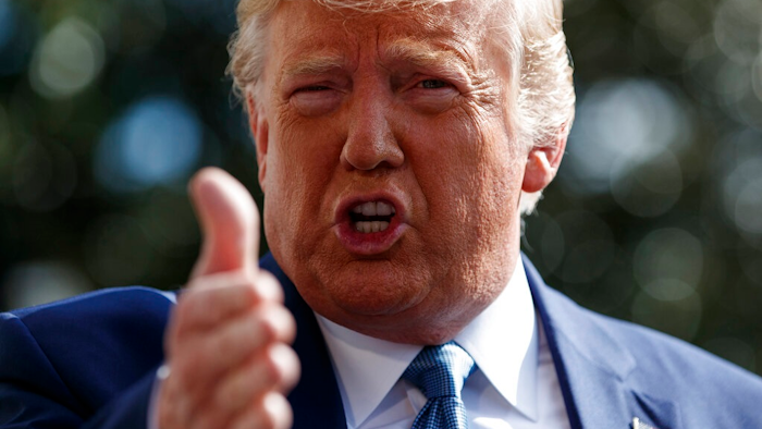 In this Oct. 4, 2019, file photo, President Donald Trump talks to reporters on the South Lawn of the White House, in Washington. The nation's business economists think President Trump's trade war with China will contribute to a sharp slowdown in economic growth this year and next, raising concerns about a possible recession starting late next year.