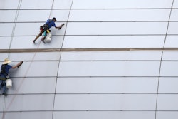 In this July 31, 2019 file photo, workers clean the outside facade of State Farm Stadium in Glendale, AZ.