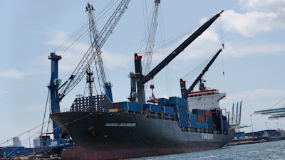 In this July 24, 2019 file photo, the container ship Hansa Augsburg is shown docked at PortMiami in Miami.