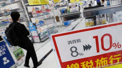 In this Sept. 30, 2019, photo, a signboard reads 'Consumption tax hike, 8 percent to 10 percent', at a mass home electronics retailer in Tokyo.