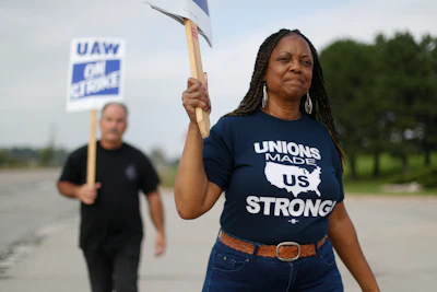 In this Sept. 30 2019, photo, United Auto Workers members picket during a strike at General Motors Orion Assembly plant in Orion Township, MI