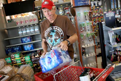 James Cooke is shown buying water bottles along with propane tanks and batteries at a ACE Hardware store as he prepares for a possible power shutdown in Los Gatos, CA on Tuesday, Oct. 8.