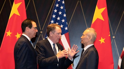 In this on Wednesday, July 31, 2019 file photo, U.S. Trade Representative Robert Lighthizer, center, gestures as he chats with Chinese Vice Premier Liu He, right, with Treasury Secretary Steven Mnuchin, left, looking on after posing for a photo at the Xijiao Conference Center in Shanghai.