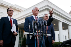 Vice President Mike Pence, with Treasury Secretary Steven Mnuchin, left, and national security adviser Robert O'Brien, speaks to reporters outside the West Wing of the White House on Monday, Oct. 14 in Washington.