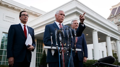 Vice President Mike Pence, with Treasury Secretary Steven Mnuchin, left, and national security adviser Robert O'Brien, speaks to reporters outside the West Wing of the White House on Monday, Oct. 14 in Washington.