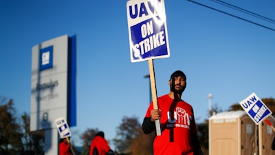 A member of the United Auto Workers walks the picket line at the General Motors Romulus Powertrain plant in Romulus, MI on Oct. 9.