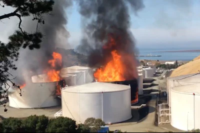 In this image from video provided by the Napa County Sheriff's Office, tanks are on fire at an oil storage facility Tuesday viewed from Rodeo, CA.