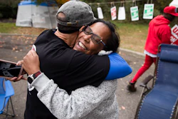 Picketing United Auto Workers Richard Rivera, left, and Robin Pinkney react to news of a tentative contract agreement with General Motors, in Langhorne, PA, on Wednesday.