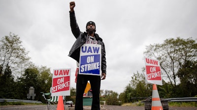 Ryan Piper with the United Auto Workers continues to picket after news of a tentative contract agreement with General Motors, in Langhorne, PA on Wednesday, Oct. 16.