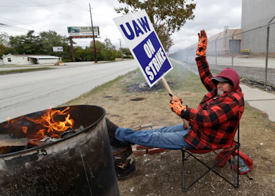 Ray Geyser, a 21-year General Motors employee, pickets outside the General Motors Fabrication Division on Wednesday, Oct. 16, in Parma, OH.