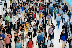 In this June 21, 2019 file photo, commuters walk through a corridor in the World Trade Center Transportation Hub in New York.