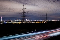Cars pass by near the skyline with the buildings of the banking district in Frankfurt, Germany, on Tuesday, Oct. 22.