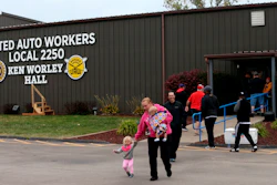 United Auto Worker Lindsey Higgins, exits the the UAW Local 2250 Ken Worley Hall with her two children after voting on the offer made to union workers by General Motors on Thursday, Oct. 24, in Wentzville, MO.