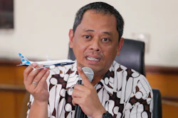 National Transportation Safety Committee investigator Nurcahyo Utomo holds a model of an airplane during a press conference in Jakarta, Indonesia. An Indonesian investigation found a Lion Air flight that crashed and killed 189 people a year ago was doomed by a combination of aircraft design flaws, inadequate training and maintenance problems.