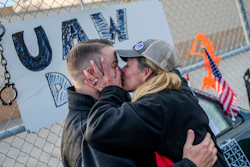 Clio resident Dawn Dekalita, 48, and a 16-year employee at the Flint Assembly Plant, plants a kiss on Shop Committee's Dustin Culhane in celebration as the United Auto Workers strike against General Motors comes to an emotional close outside of the Flint Assembly Plant on Friday in Flint, MI.
