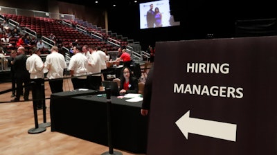 In this Tuesday, June 4, 2019 file photo, managers wait for job applicants at the Seminole Hard Rock Hotel & Casino Hollywood during a job fair in Hollywood, FL.