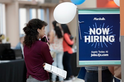 In this Oct. 1, 2019 file photo, Daisy Ronco waits in line to apply for a job with Marshalls during a job fair at Dolphin Mall in Miami.